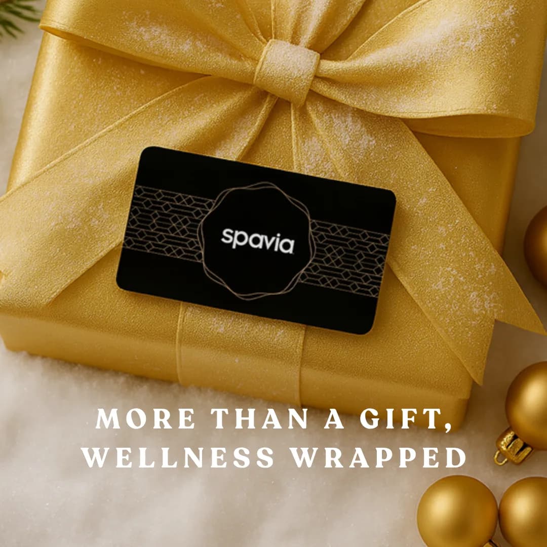 A Spavia gift card on a gold-wrapped present, from our holiday gift designs