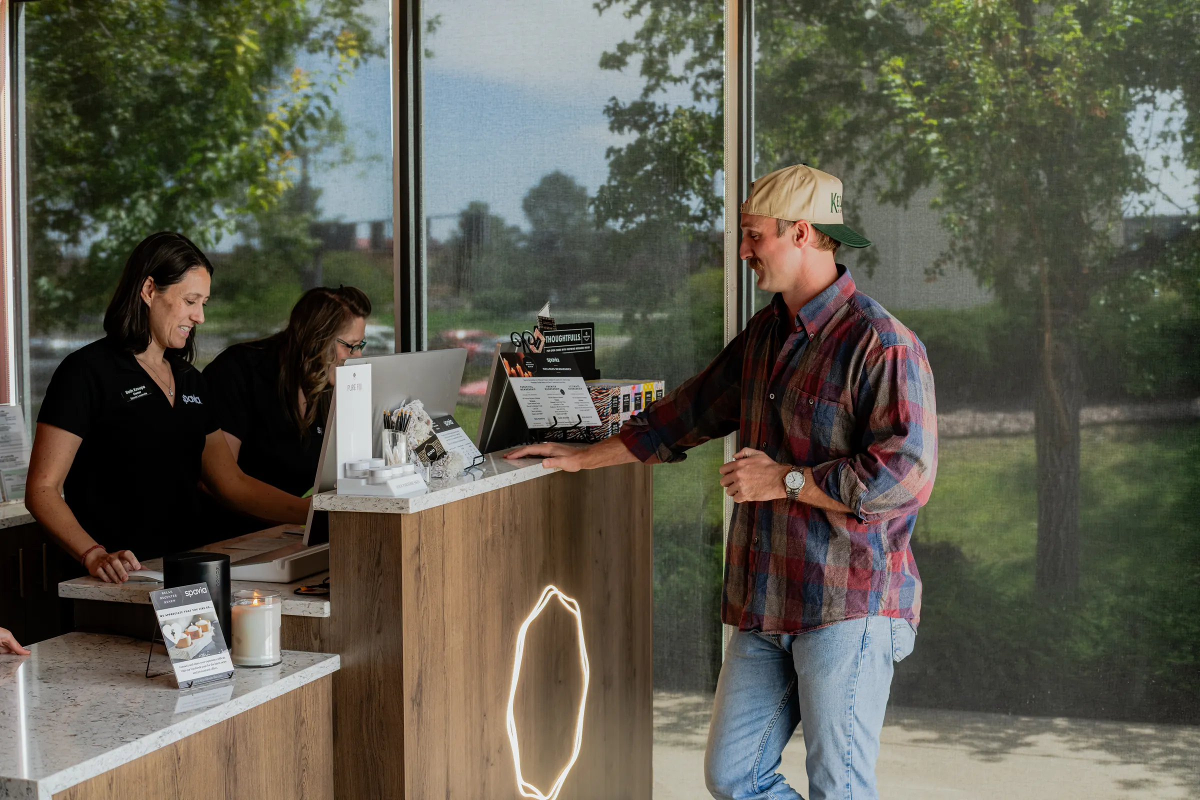 Spavia team members checking in a guest at the front desk