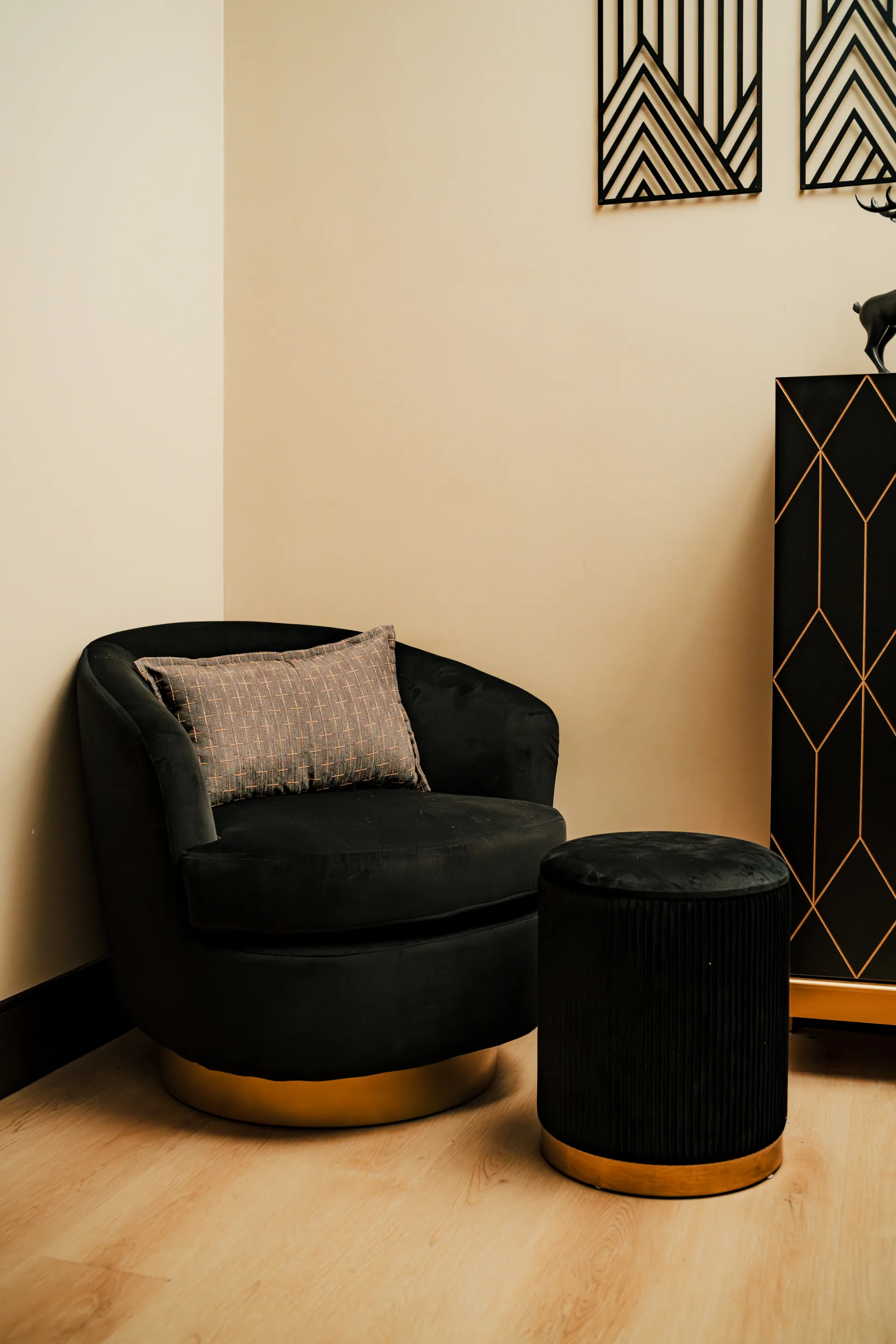 A plush chair and ottoman in a quiet, softly lit corner of a Spavia spa