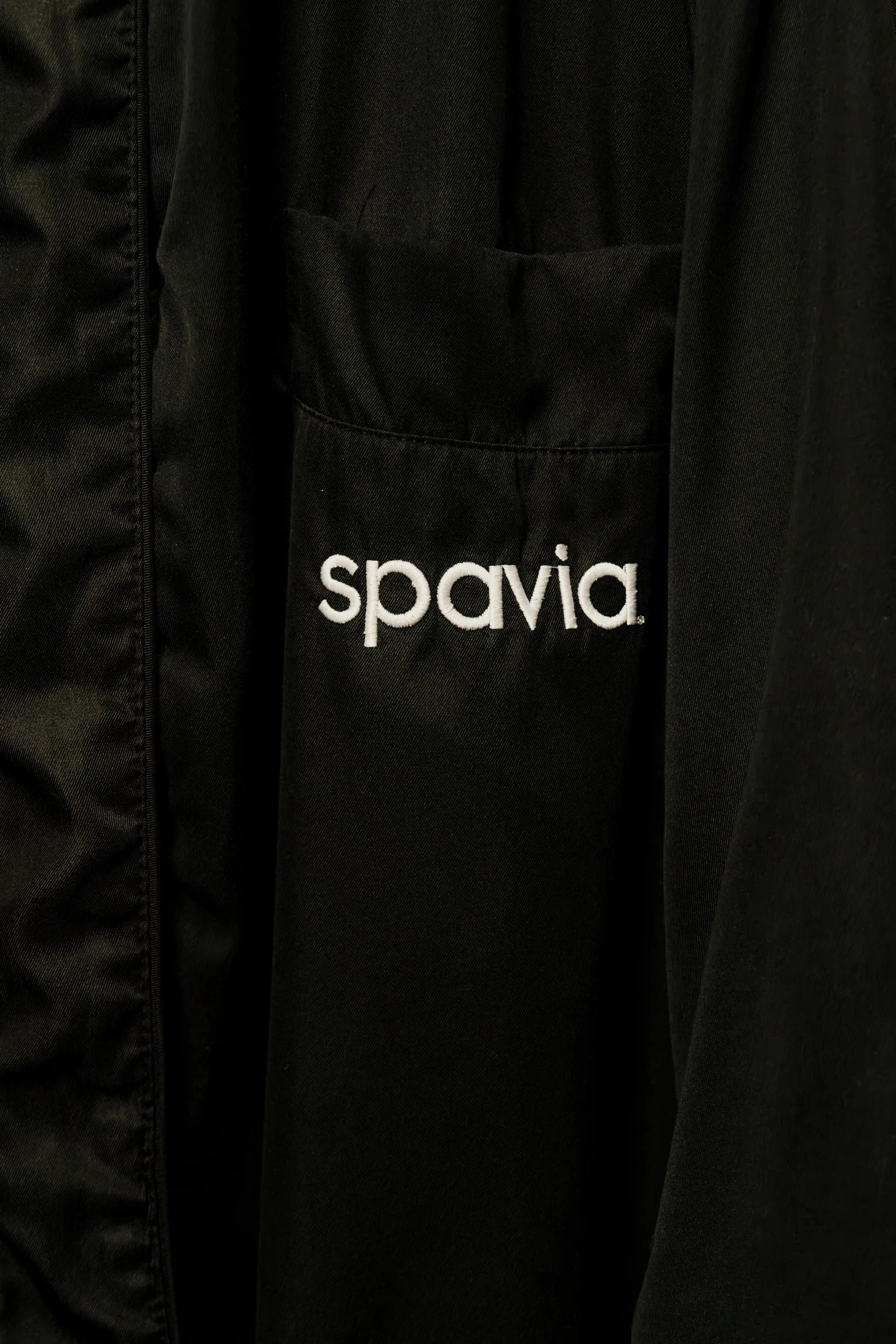 The Spavia logo embroidered on a guest robe pocket