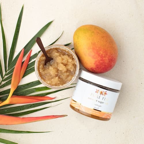 Fruit and leaves with a container of Coconut Sugar Rub