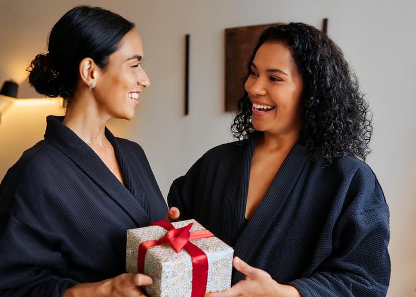 woman giving her friend a gift at spavia day spa